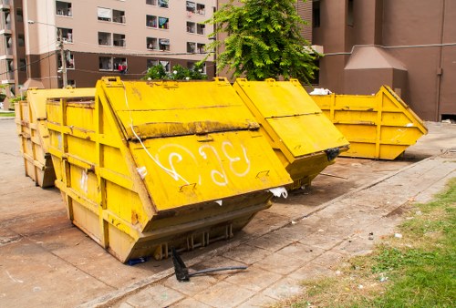 People disposing of furniture in Southfields recycling center